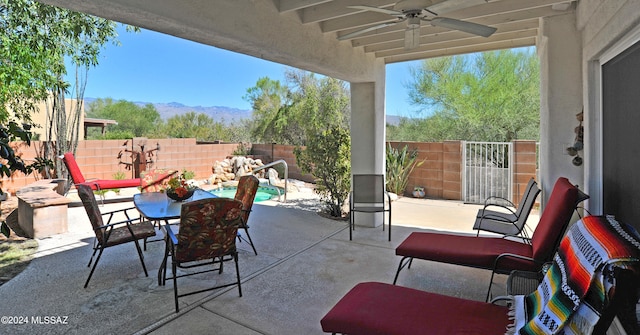 view of patio / terrace with a mountain view and ceiling fan