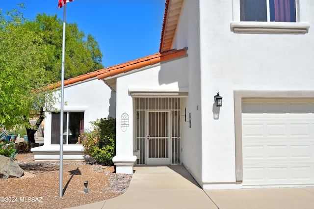 view of exterior entry with a garage