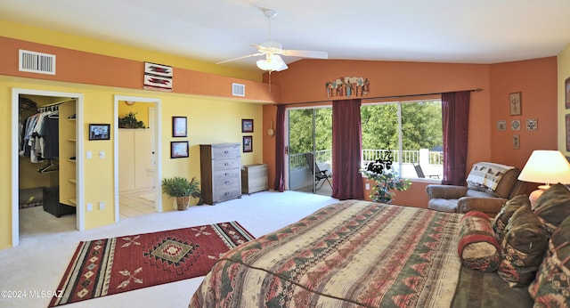 bedroom with ceiling fan, a walk in closet, access to exterior, light carpet, and vaulted ceiling