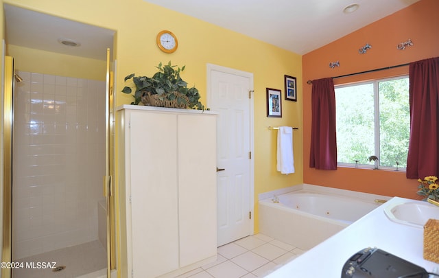 bathroom with shower with separate bathtub, tile patterned flooring, vaulted ceiling, and double sink