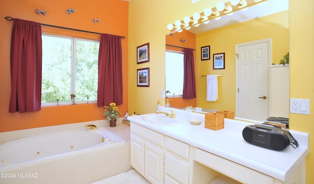 bathroom featuring vanity and a relaxing tiled tub