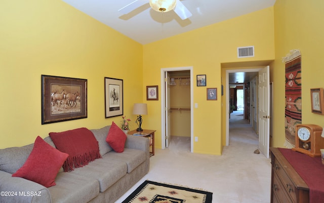 living room featuring ceiling fan and light colored carpet