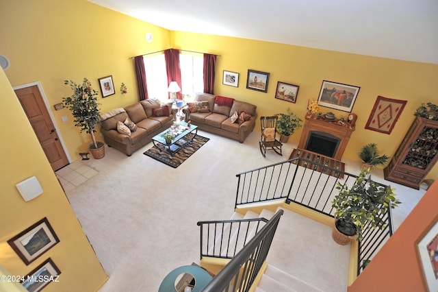 carpeted living room featuring vaulted ceiling