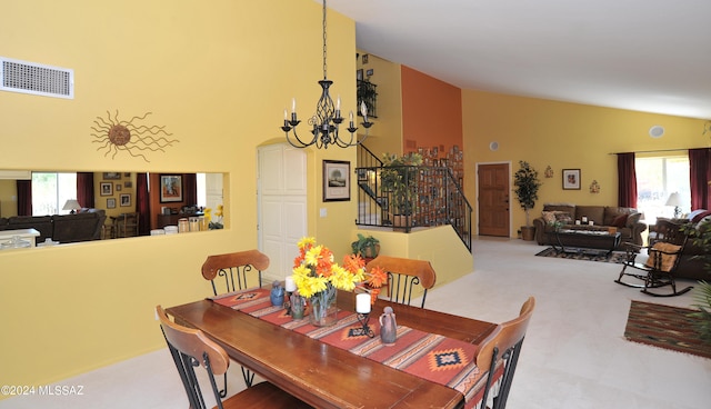 dining area featuring high vaulted ceiling, light carpet, and a chandelier