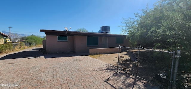 rear view of house featuring a patio and cooling unit