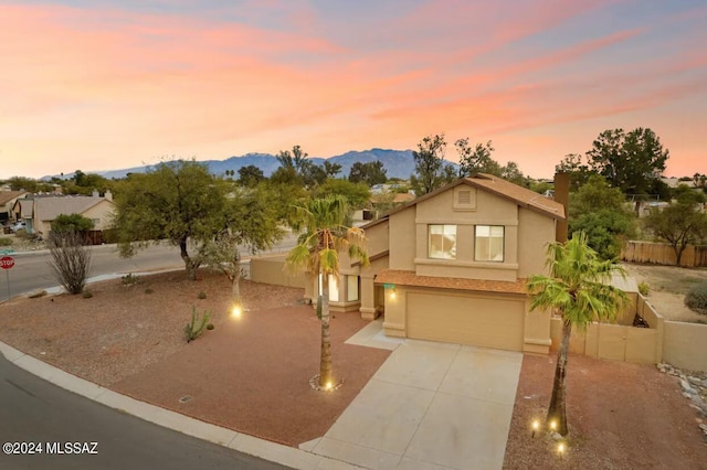 view of front of property with a mountain view and a garage