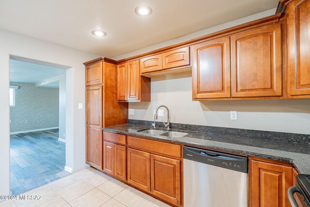 kitchen with stainless steel dishwasher, a sink, brown cabinets, and electric range