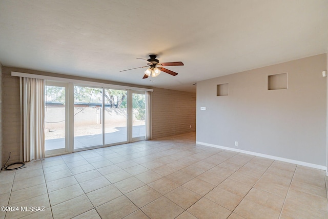 unfurnished room featuring light tile patterned floors, ceiling fan, and baseboards