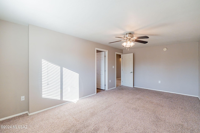 empty room featuring ceiling fan, carpet, and baseboards