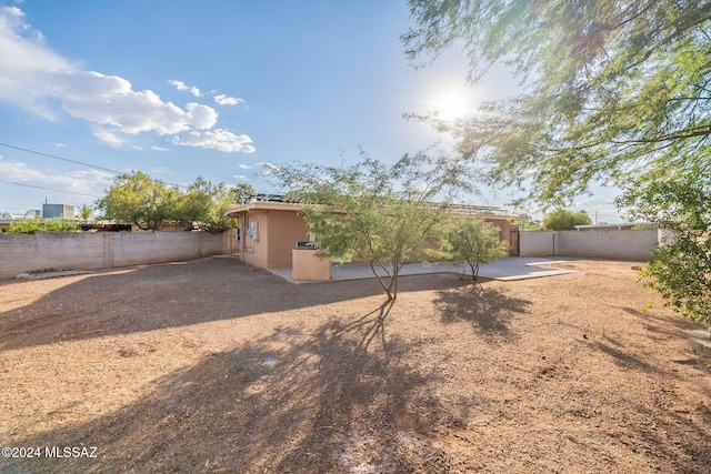 view of yard with a patio and a fenced backyard