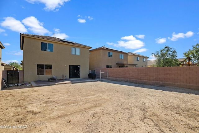 398 W Cedar Chase Dr, Green Valley, AZ 85614 - back of property with a patio, roof mounted solar panels, a fenced backyard, and stucco siding