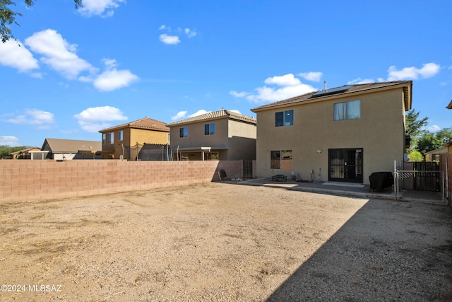398 W Cedar Chase Dr, Green Valley, AZ 85614 - rear view of house featuring a fenced backyard, solar panels, a patio, and stucco siding