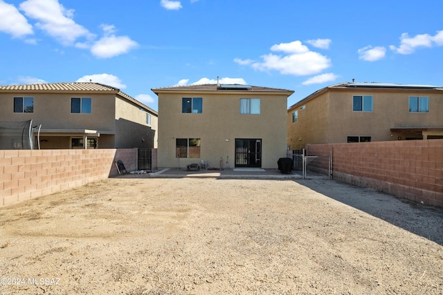 398 W Cedar Chase Dr, Green Valley, AZ 85614 - rear view of property featuring a patio, roof mounted solar panels, a fenced backyard, and stucco siding