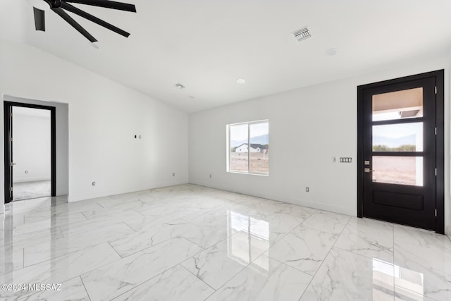 foyer entrance featuring vaulted ceiling and ceiling fan