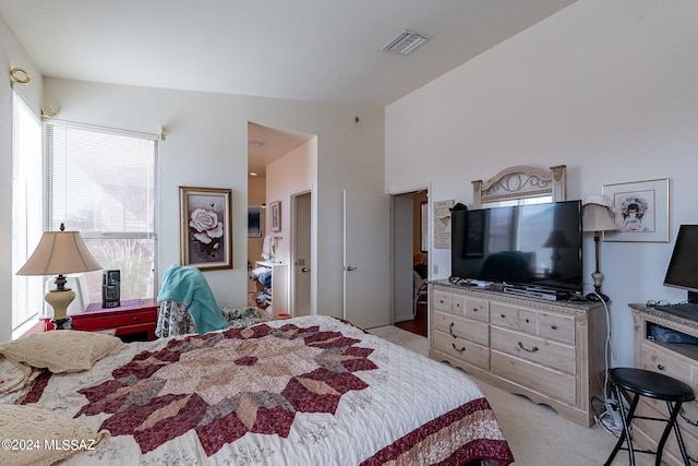 carpeted bedroom with lofted ceiling