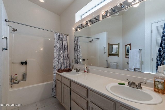 full bathroom with shower / tub combo with curtain, tile patterned flooring, vanity, and toilet