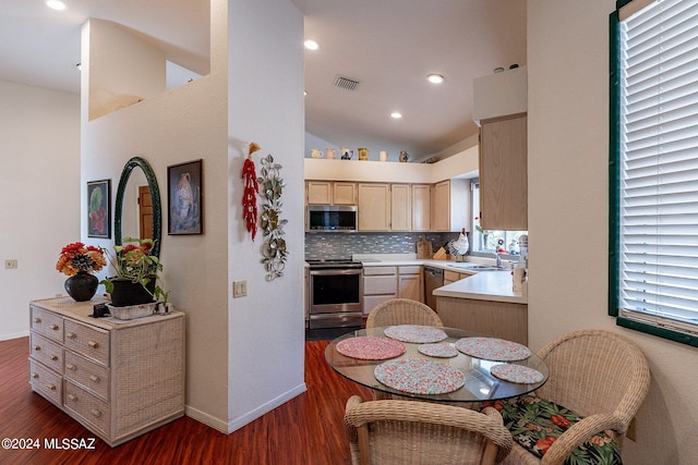 kitchen featuring light brown cabinets, backsplash, appliances with stainless steel finishes, and dark hardwood / wood-style floors