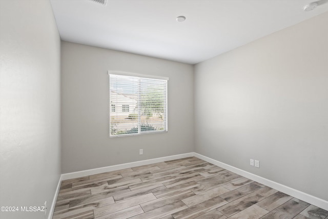 spare room with light hardwood / wood-style flooring