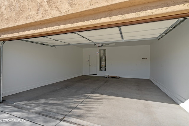 garage with water heater and a garage door opener