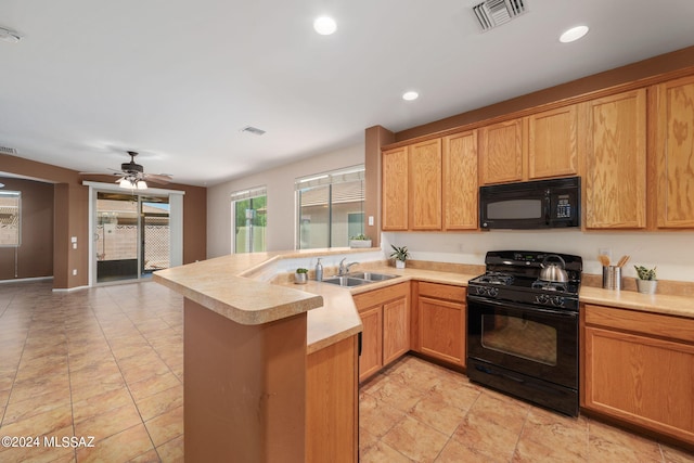 kitchen with kitchen peninsula, black appliances, ceiling fan, and sink