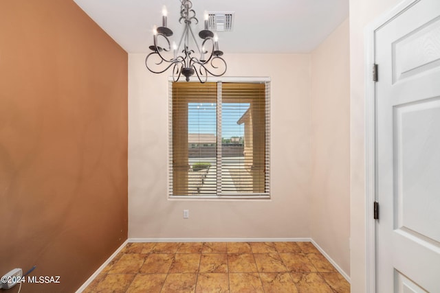 unfurnished dining area with a chandelier