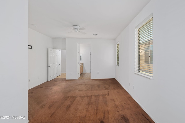 unfurnished room featuring carpet and ceiling fan