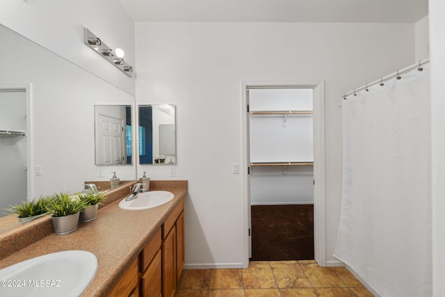 bathroom featuring tile patterned flooring and vanity