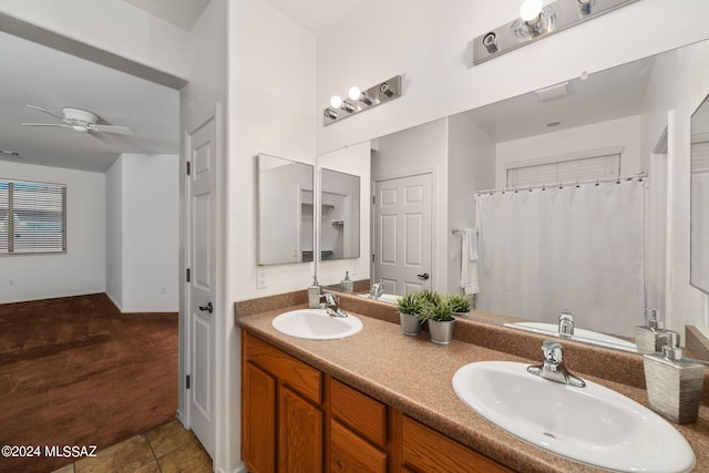 bathroom featuring tile patterned flooring, ceiling fan, walk in shower, and vanity