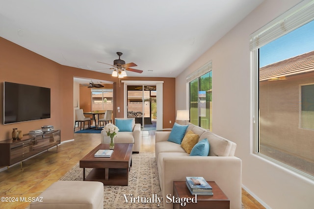 living room with ceiling fan and light wood-type flooring