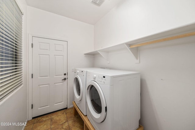 laundry room with washing machine and dryer and tile patterned floors