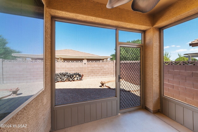 sunroom / solarium with ceiling fan and a wealth of natural light