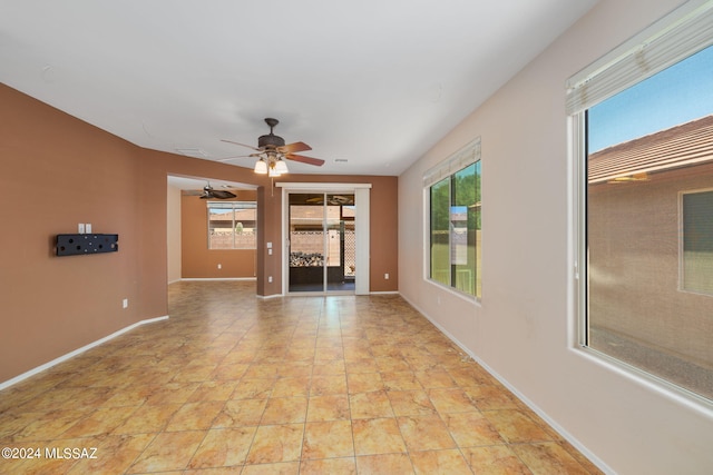 unfurnished living room featuring ceiling fan