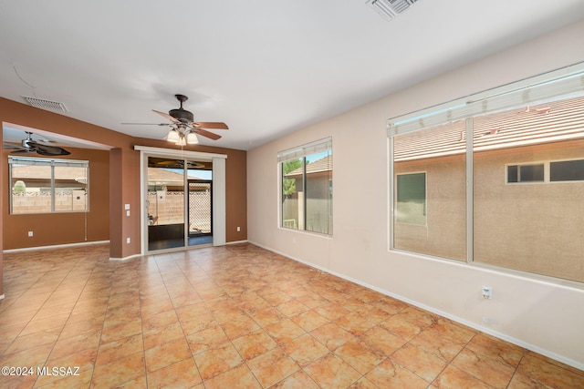 tiled spare room featuring ceiling fan