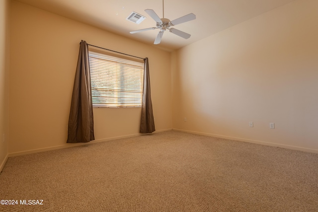 carpeted spare room with ceiling fan