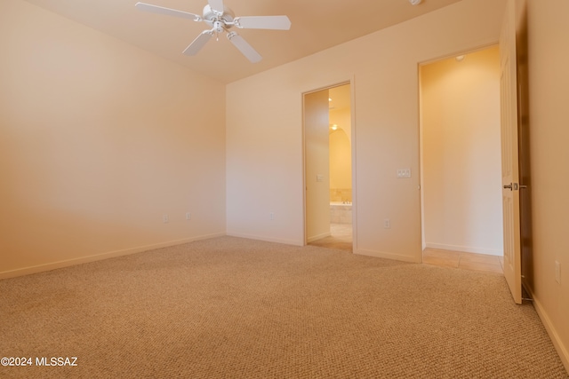 unfurnished room featuring light carpet and ceiling fan