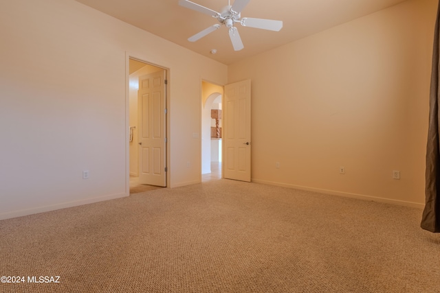 carpeted spare room featuring ceiling fan