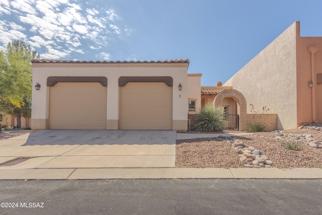 mediterranean / spanish-style home with a garage