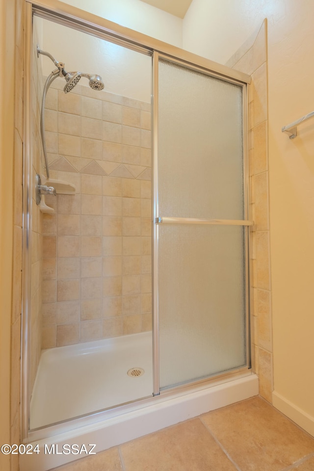 bathroom with tile patterned floors and an enclosed shower