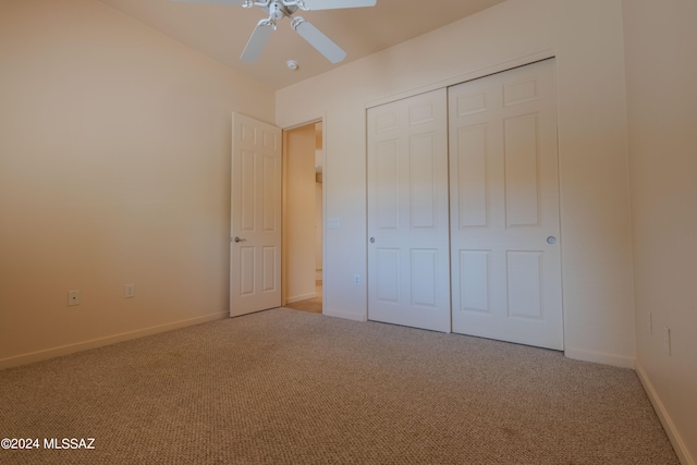 unfurnished bedroom with carpet, ceiling fan, and a closet