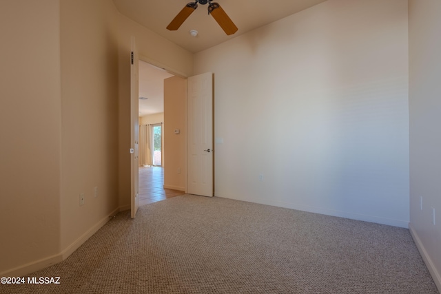 carpeted empty room featuring ceiling fan