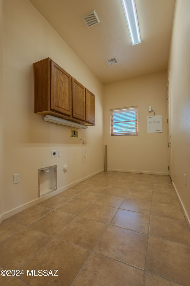 laundry room featuring washer hookup, light tile patterned floors, hookup for a gas dryer, electric dryer hookup, and cabinets