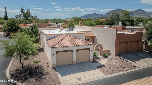 view of front of home featuring a mountain view and a garage