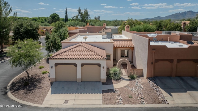 view of front of house with a mountain view and a garage