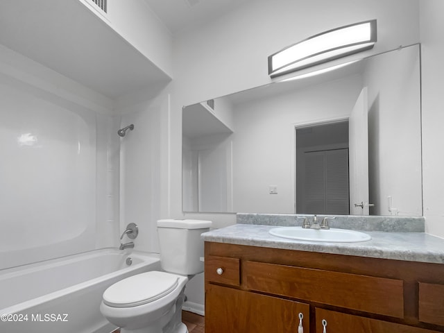 full bathroom featuring tub / shower combination, vanity, and toilet