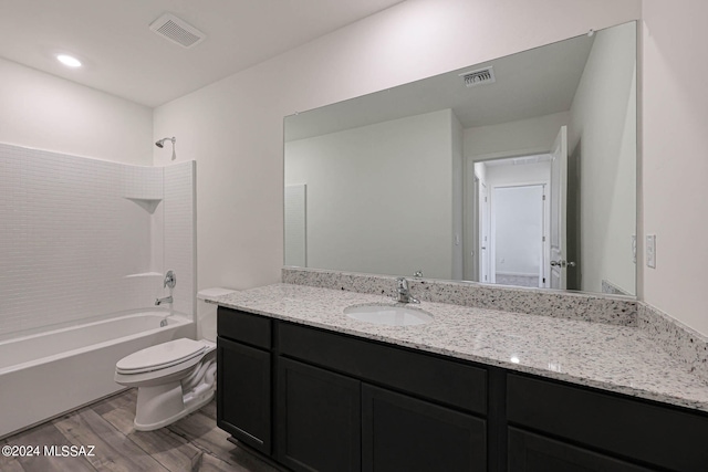 full bathroom featuring washtub / shower combination, vanity, toilet, and hardwood / wood-style flooring