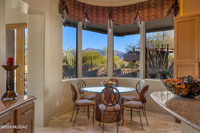 dining room featuring a mountain view and a healthy amount of sunlight