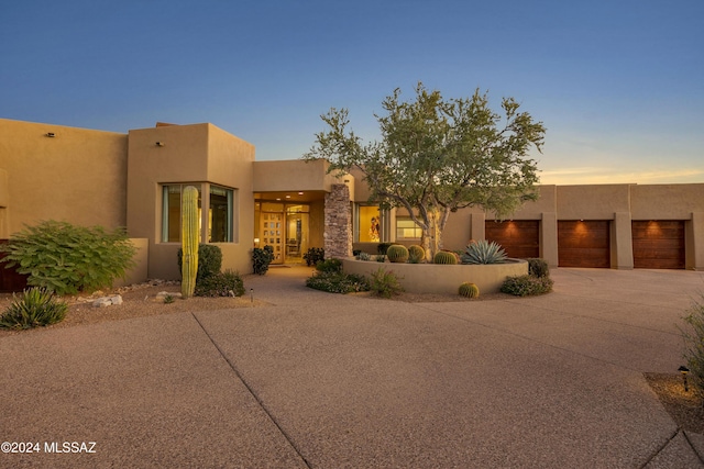 pueblo-style home with a garage