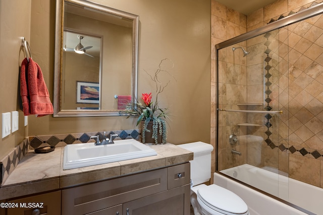 full bathroom featuring vanity, ceiling fan, enclosed tub / shower combo, and toilet