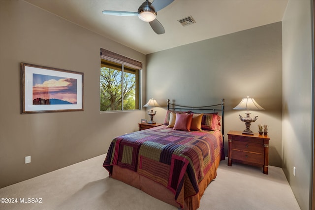 bedroom with ceiling fan and light colored carpet