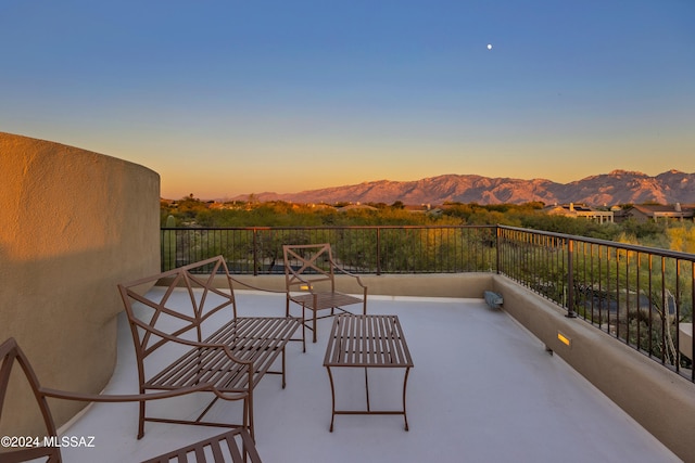 patio terrace at dusk featuring a mountain view